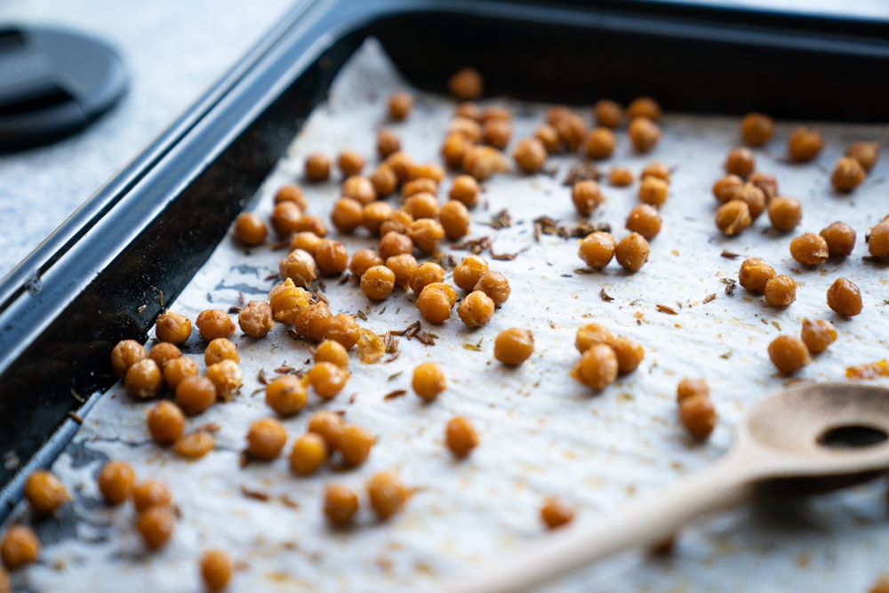 a pan filled with chickpeas and a wooden spoon