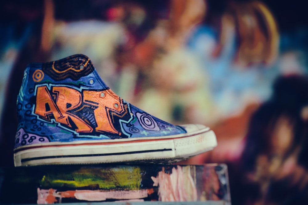 unpaired blue and orange high-top sneaker