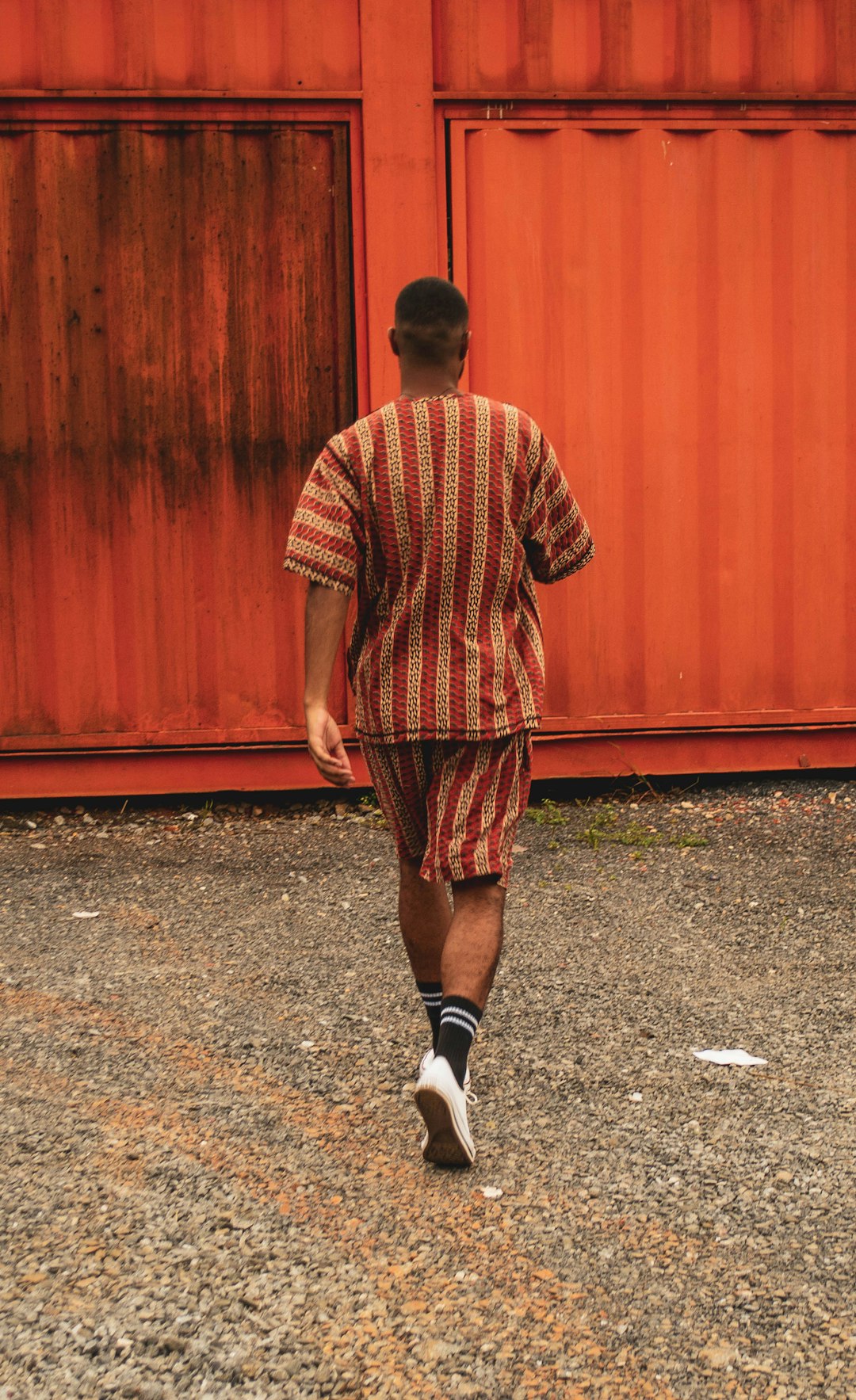 man walking towards intermodal container