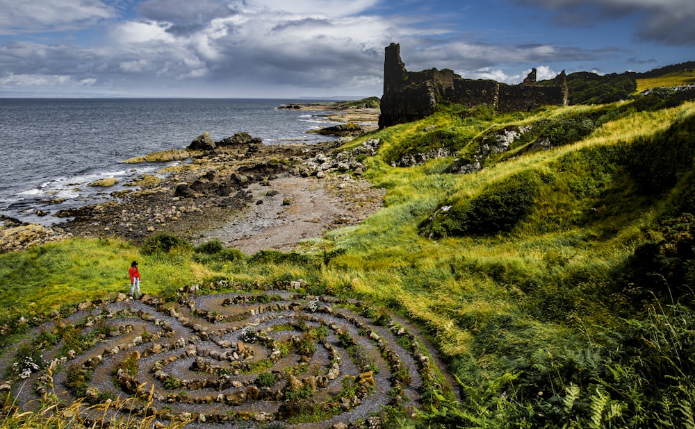 green rock formation near sea