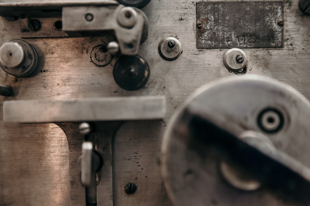 a close up of a metal door with knobs