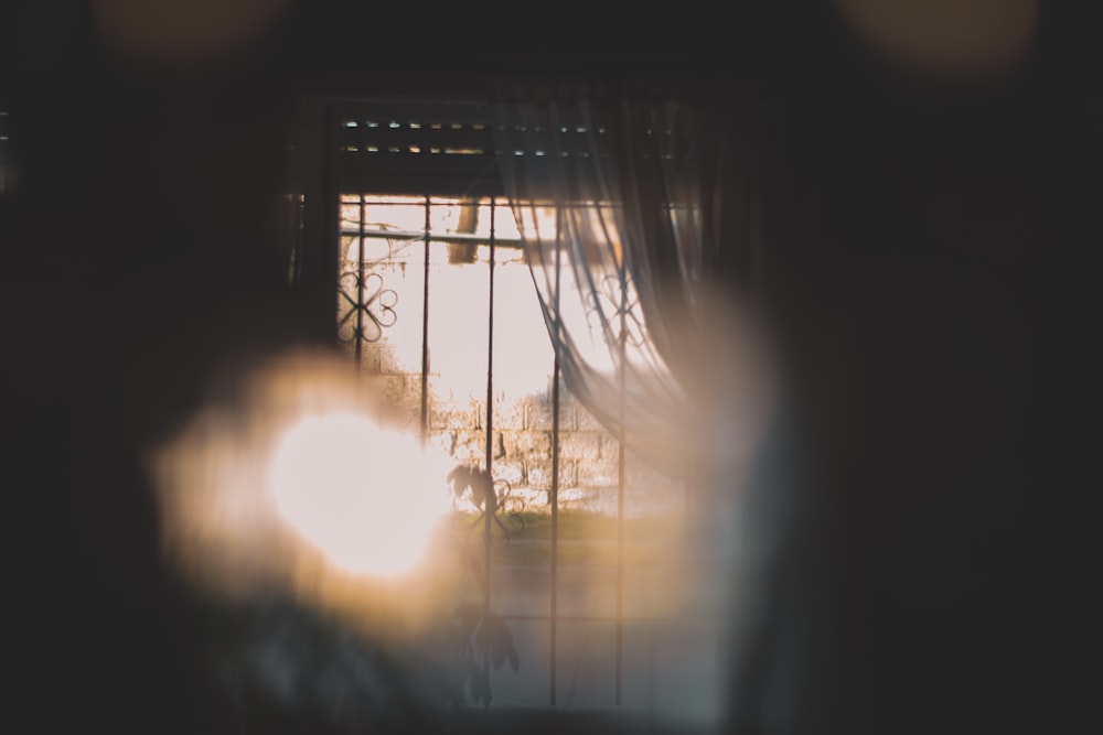 a blurry photo of a window with the sun shining through it
