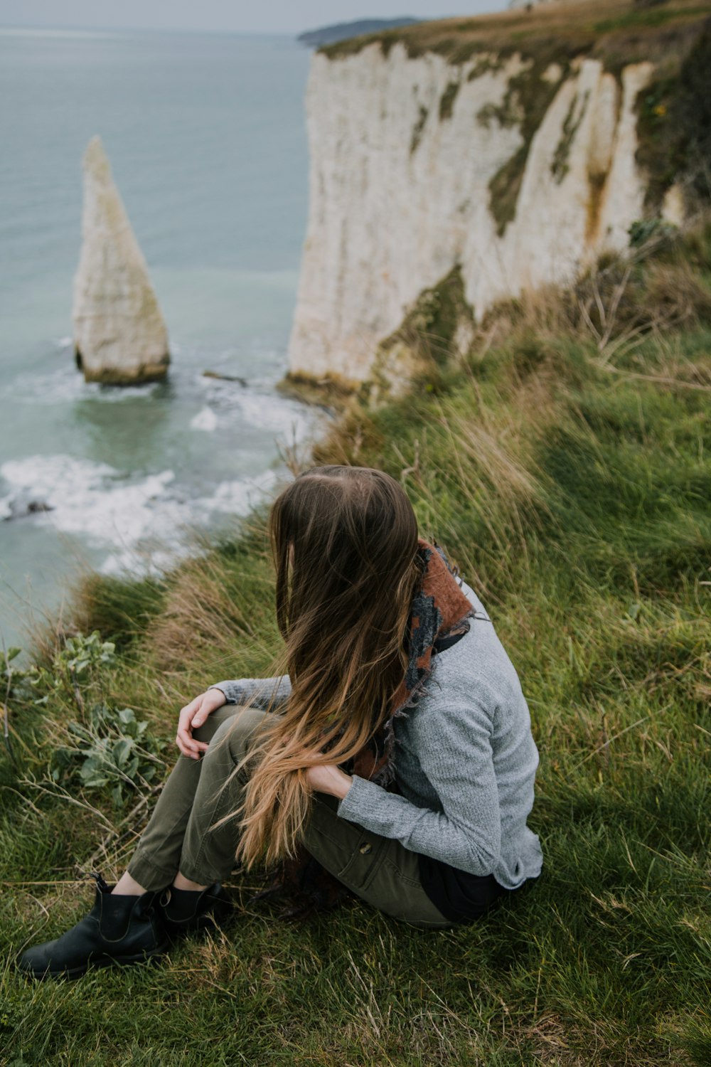 woman wears blue crew-neck sweater