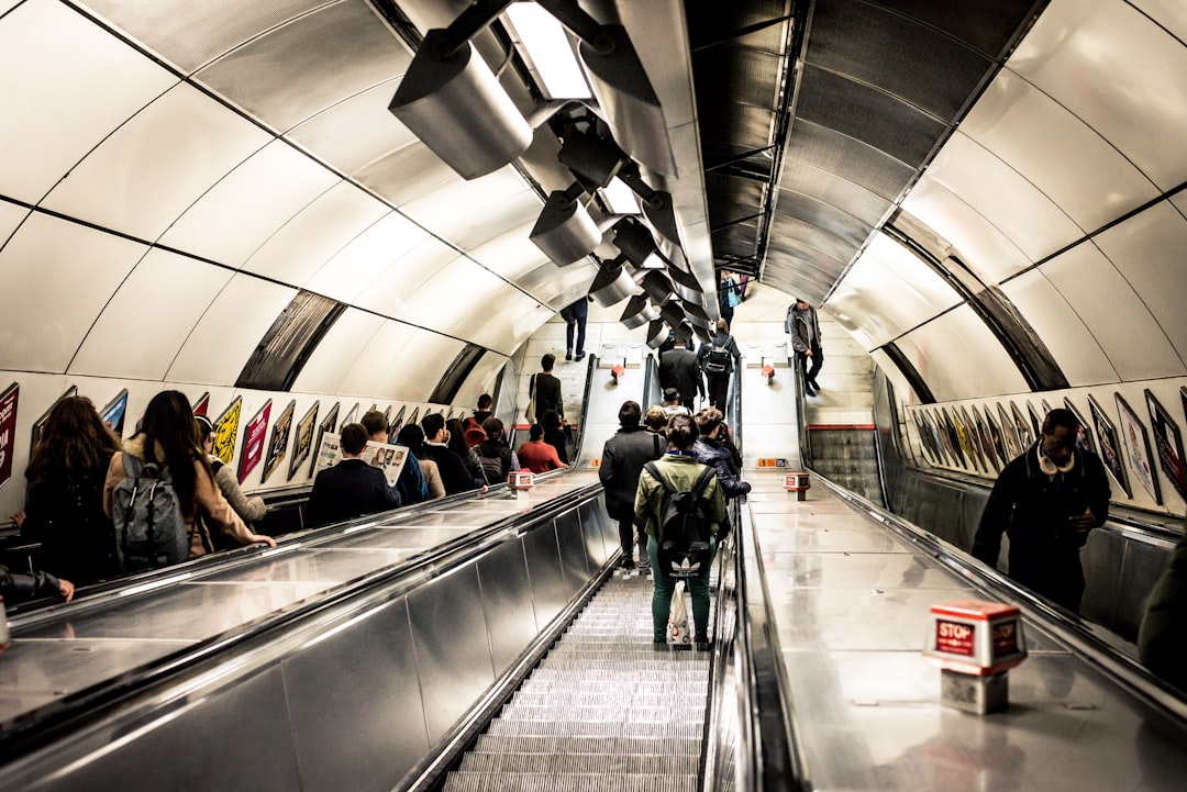 people standing on escalator inside building