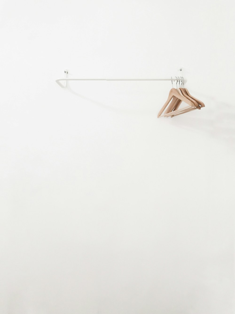 beige wooden clothes hangers