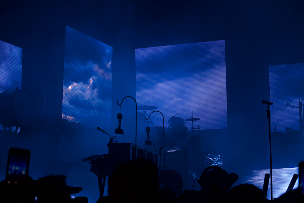 a group of people that are standing in front of a stage