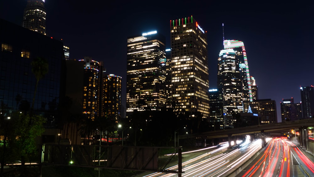 time lapse photography of city with high-rise buildings during night time