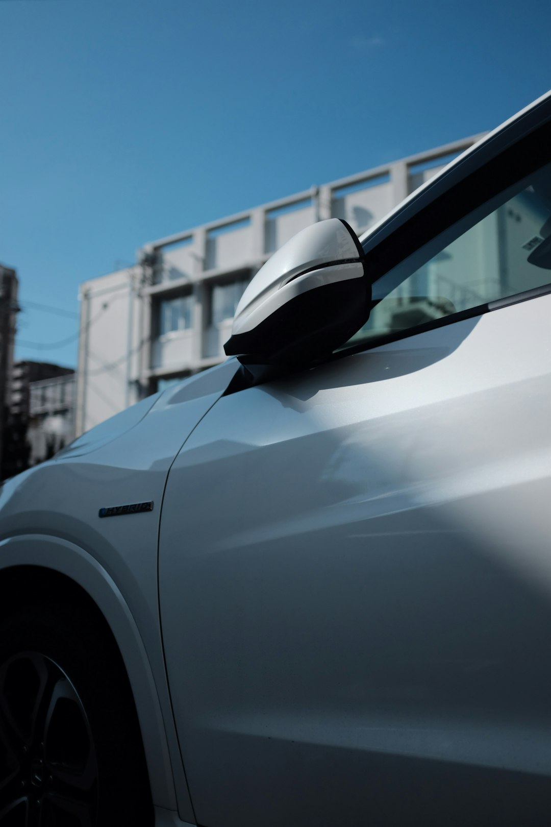 white vehicle showing side mirror