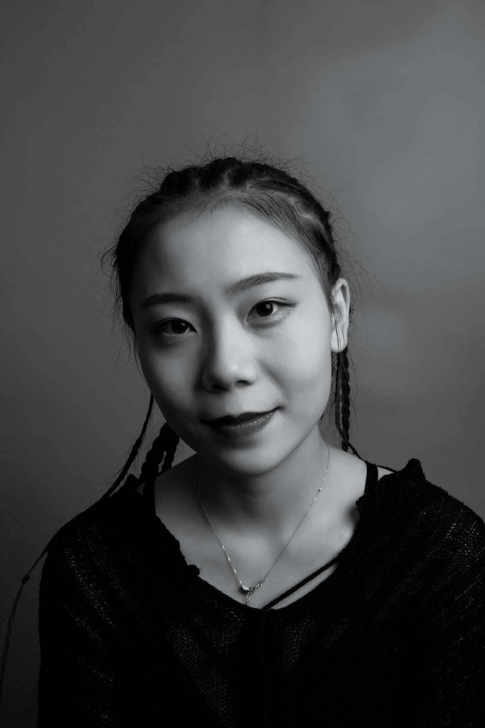 grayscale photo of woman with braided hair