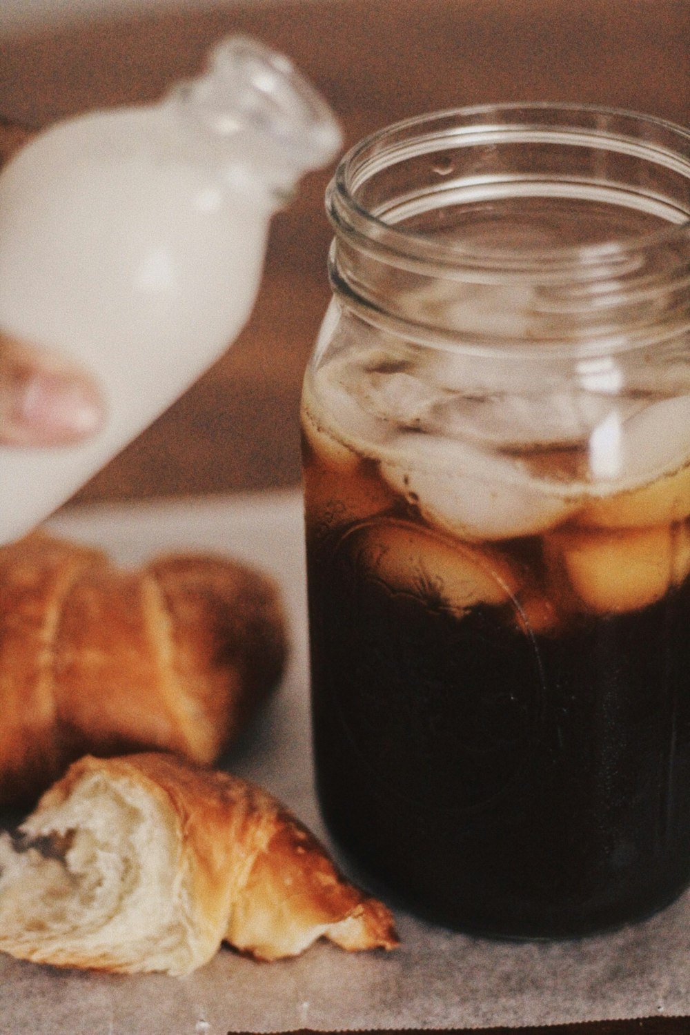 filled clear glass jar and breads