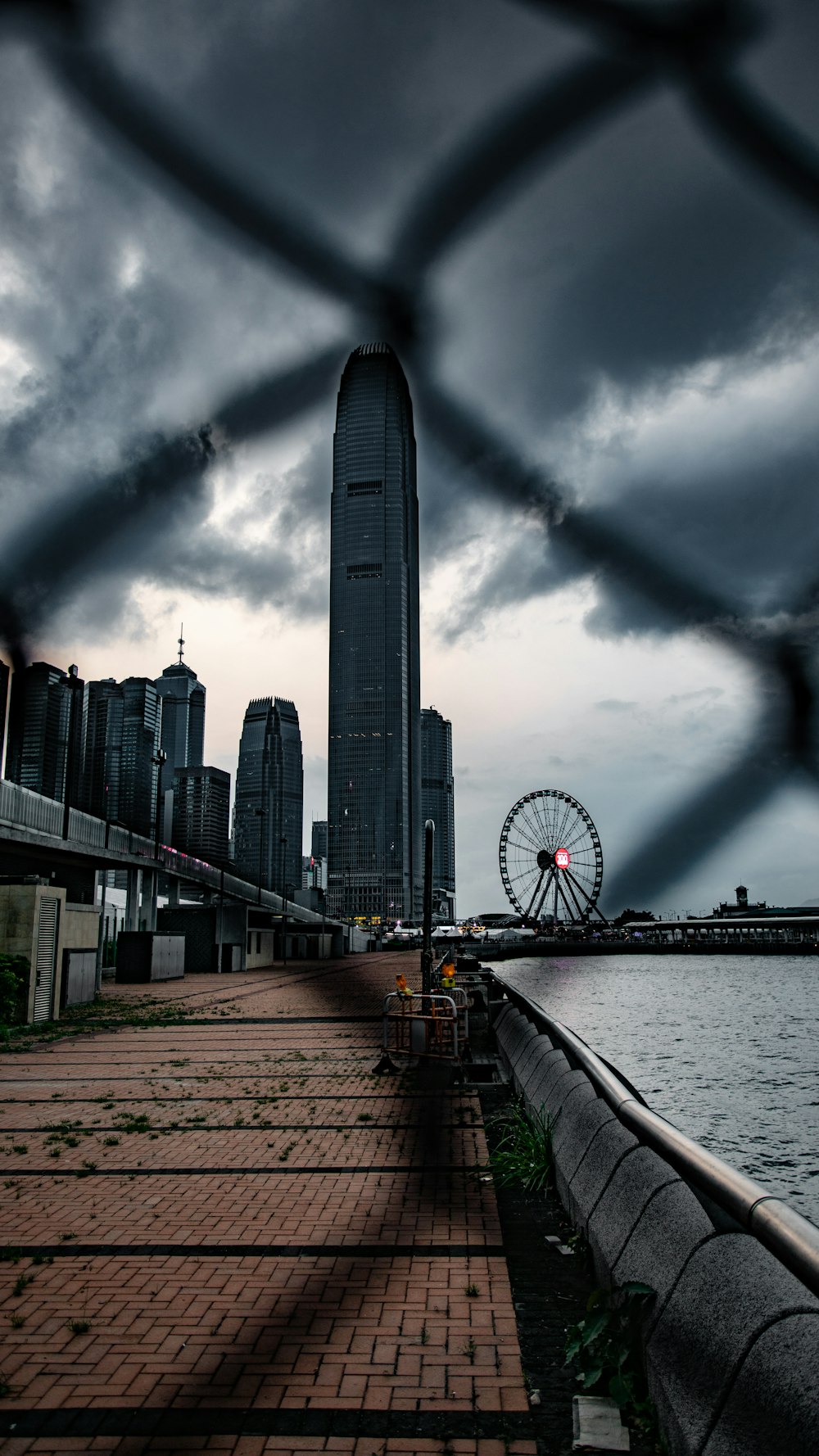 grayscale photo of sea beside building