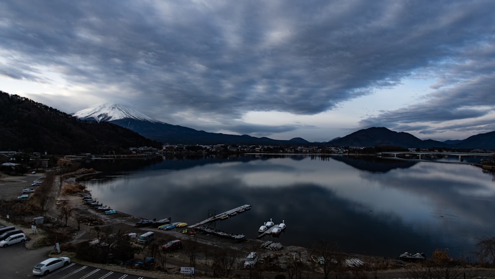 blue body of water under nimbus clouds