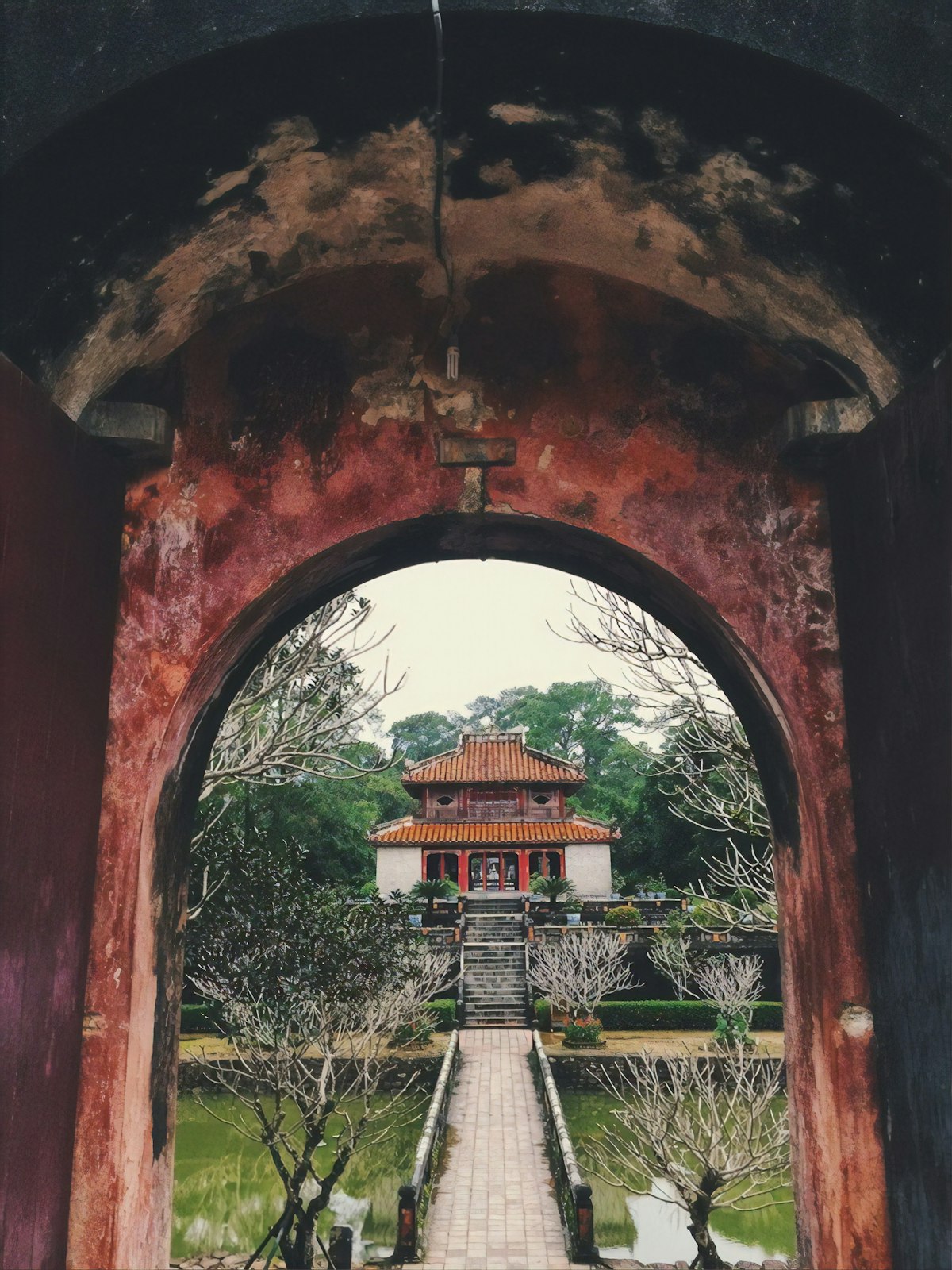 Hue April — Thien Mu pagoda tower beside the Perfume River in warm light