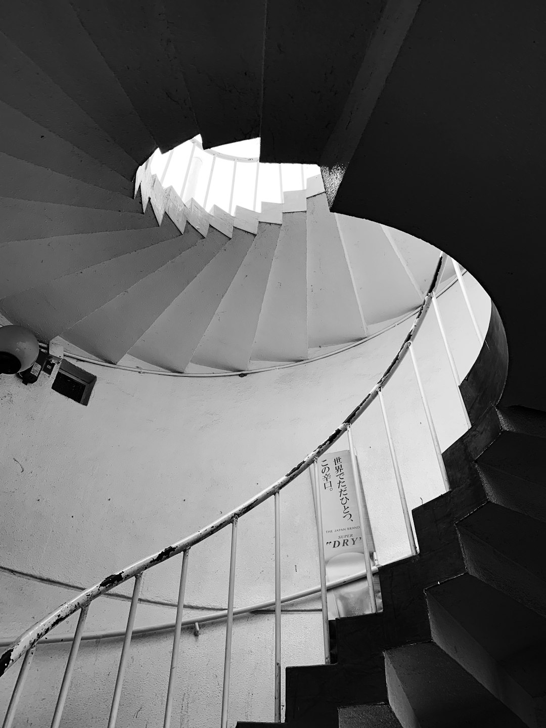 grayscale photography of low-angle curved stair