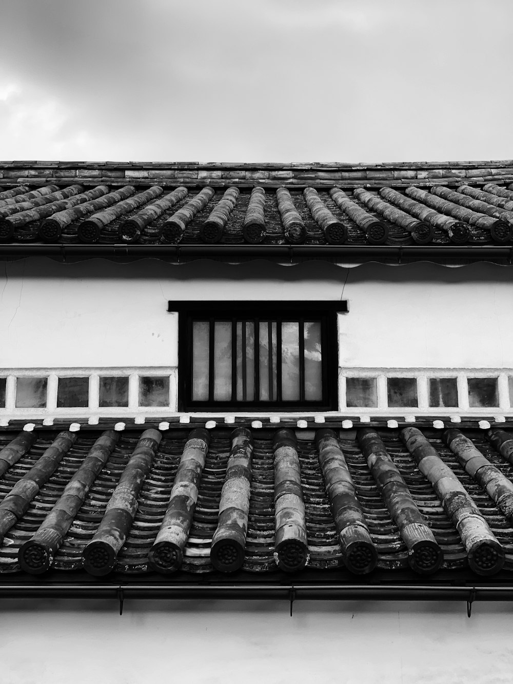 grayscale photography of bamboo roof house