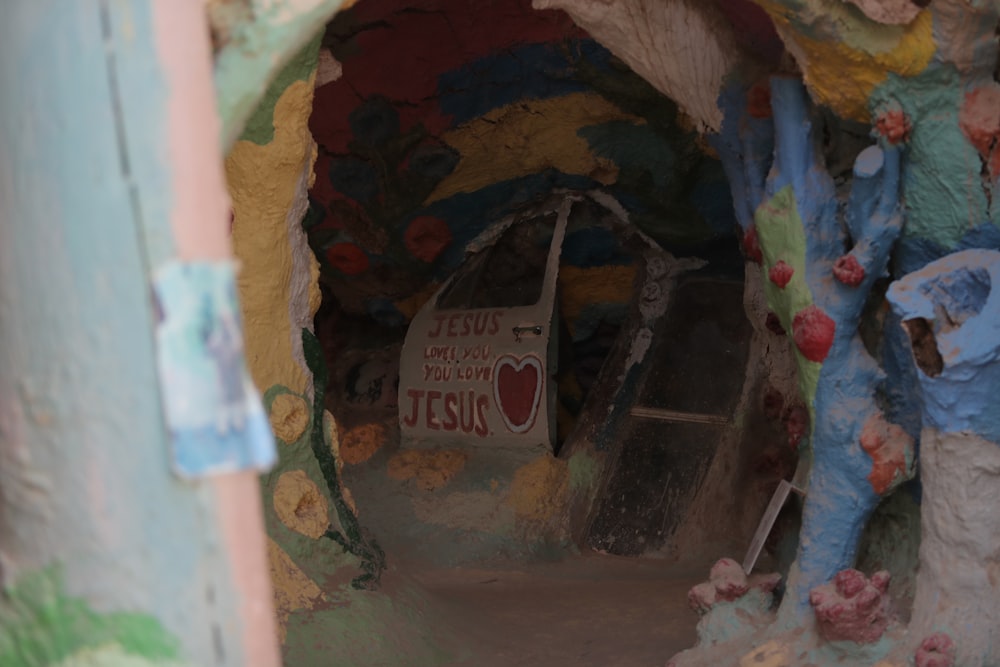 a painted tunnel with a sign that says jesus