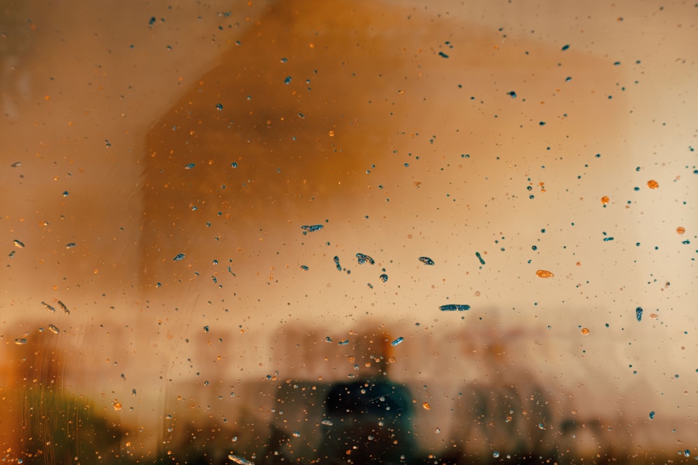 a view of a building through a rain covered window