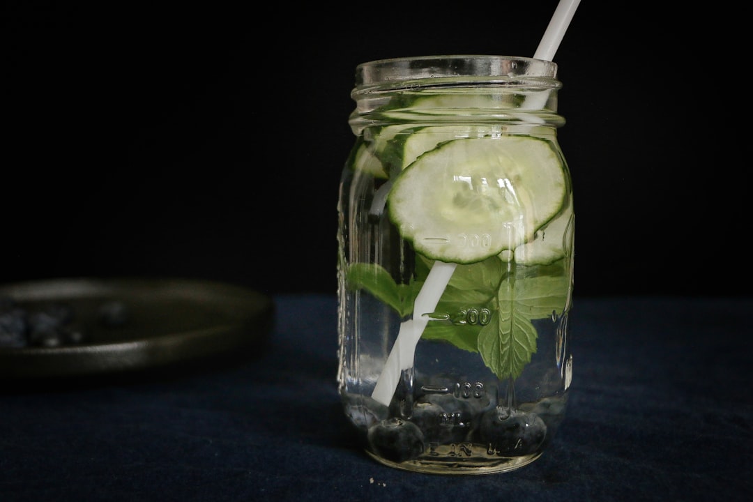 clear glass jar with water and green leafy vegetable