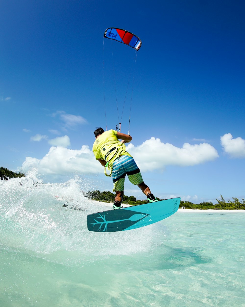 a man riding a surfboard on top of a wave