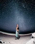 woman standing on sand at night