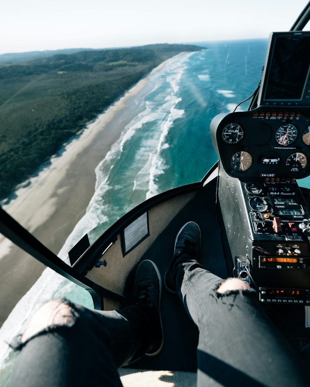 person wearing black ripped skinny jeans on helicopter