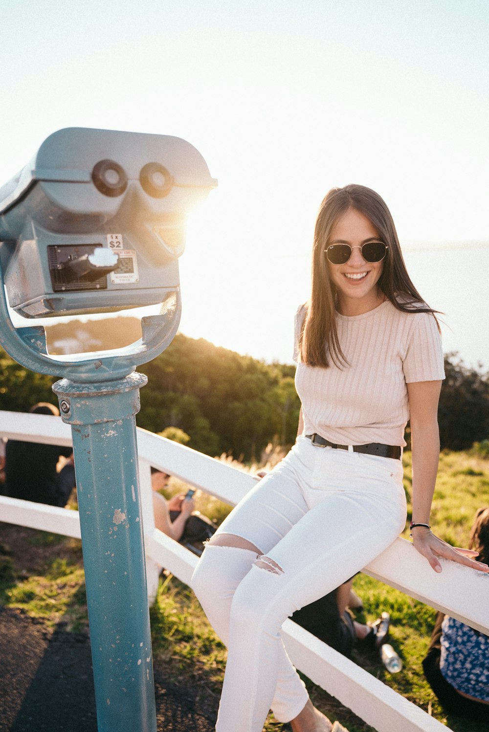 woman sitting beside tower viewer