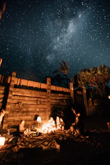 Campfire gathering under a starry night sky in the Sindh desert.