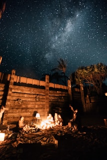 Families gathered around a campfire in the Negev desert, sharing stories under a starry sky.