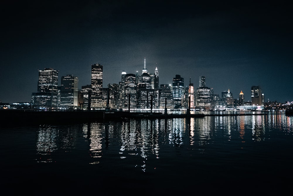 body of water across city buildings during nighttime