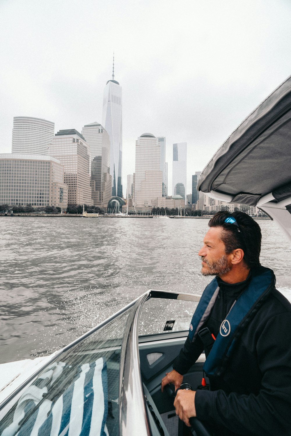 man inside white boat on body of water