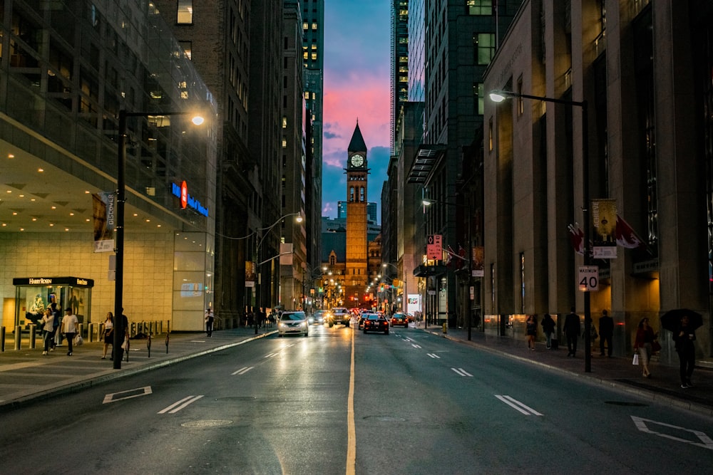 people walking on sidewalk during night time