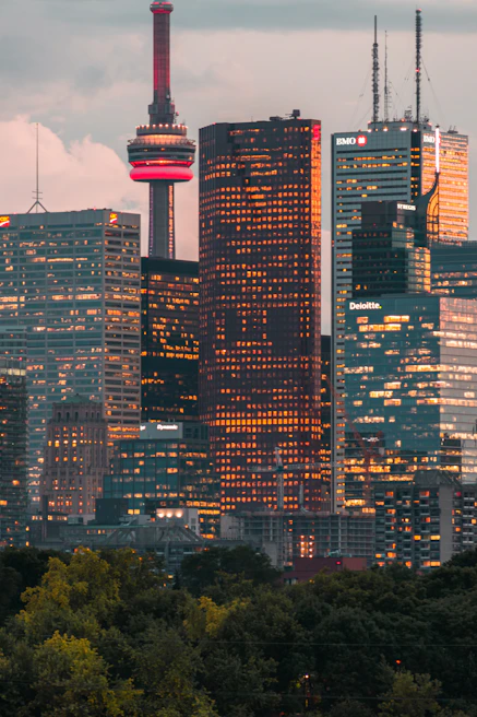 The Toronto skyline at dusk with subtle digital overlays representing data flow and AI integration.