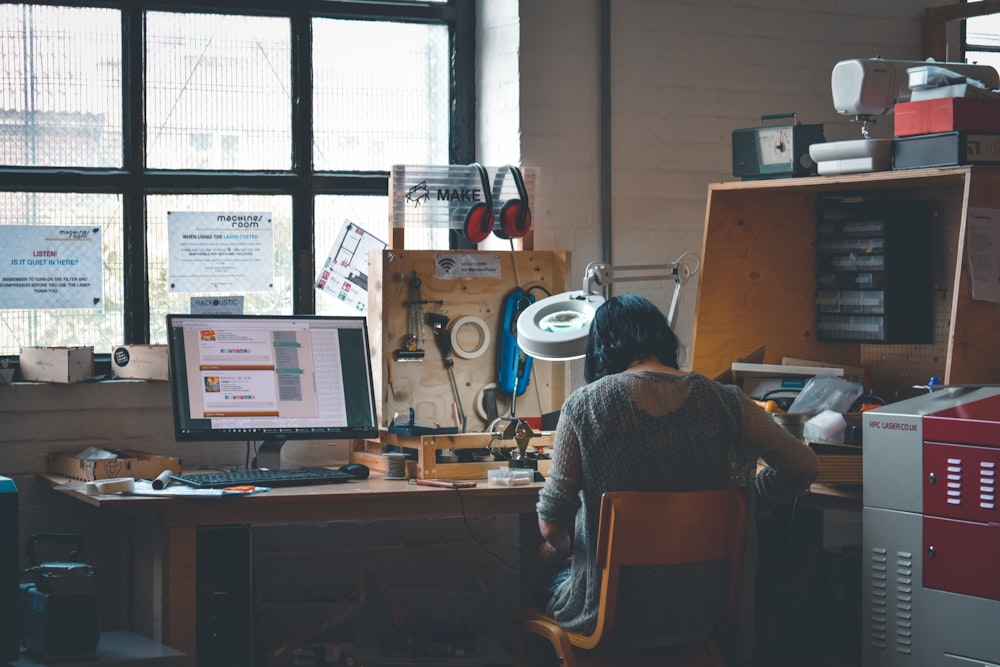 woman sitting in front of a wooden desk