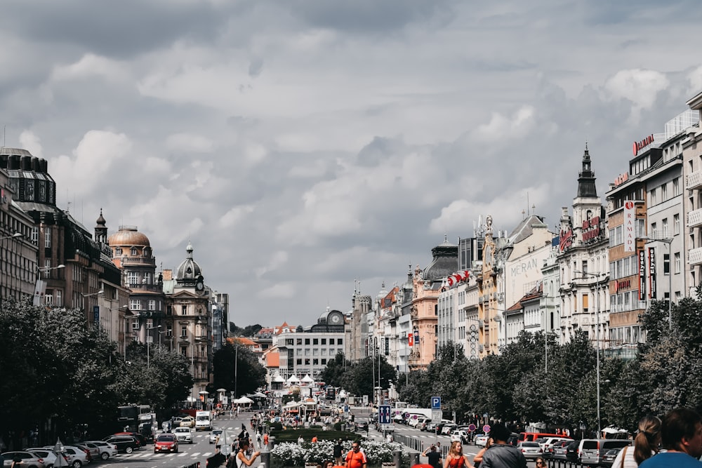 people near road viewing city with high-rise buildings during daytime