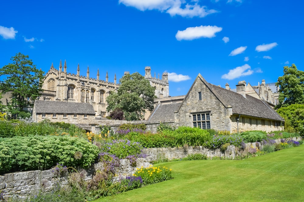 a large stone building with a garden in front of it