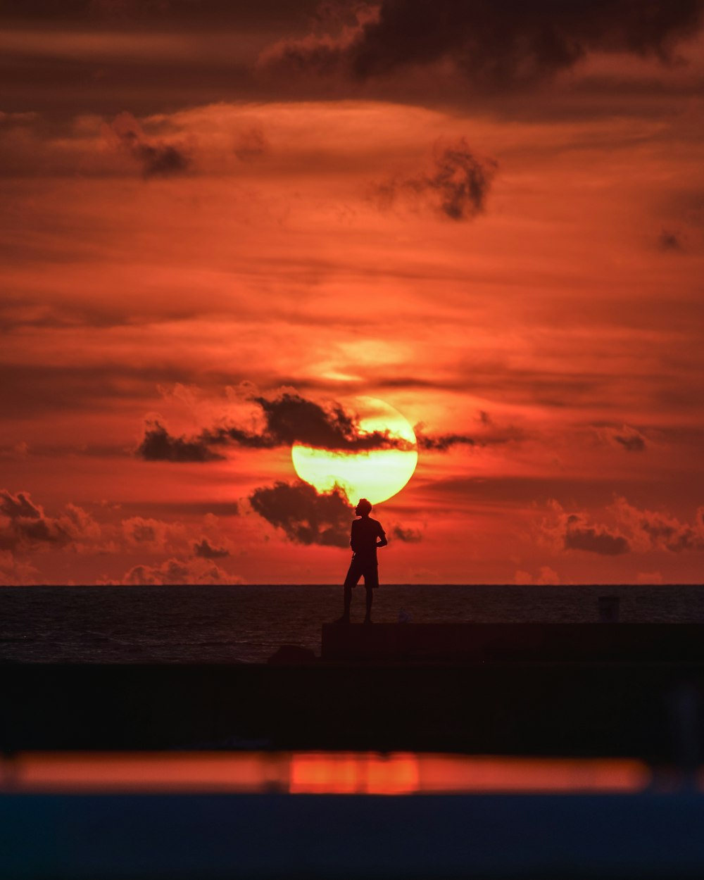 man standing on rock at night