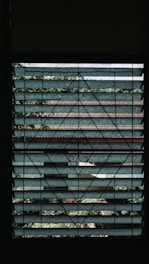 A modern home window fitted with a nearly invisible safety grill blending seamlessly.