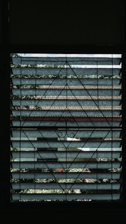 A modern home window fitted with a nearly invisible safety grill blending seamlessly.