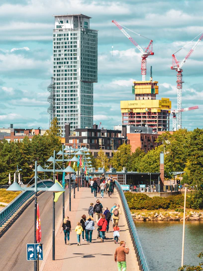 A vibrant aerial view of the Johor Bahru city center highlighting the pedestrian bridge connecting to the future RTS station.
