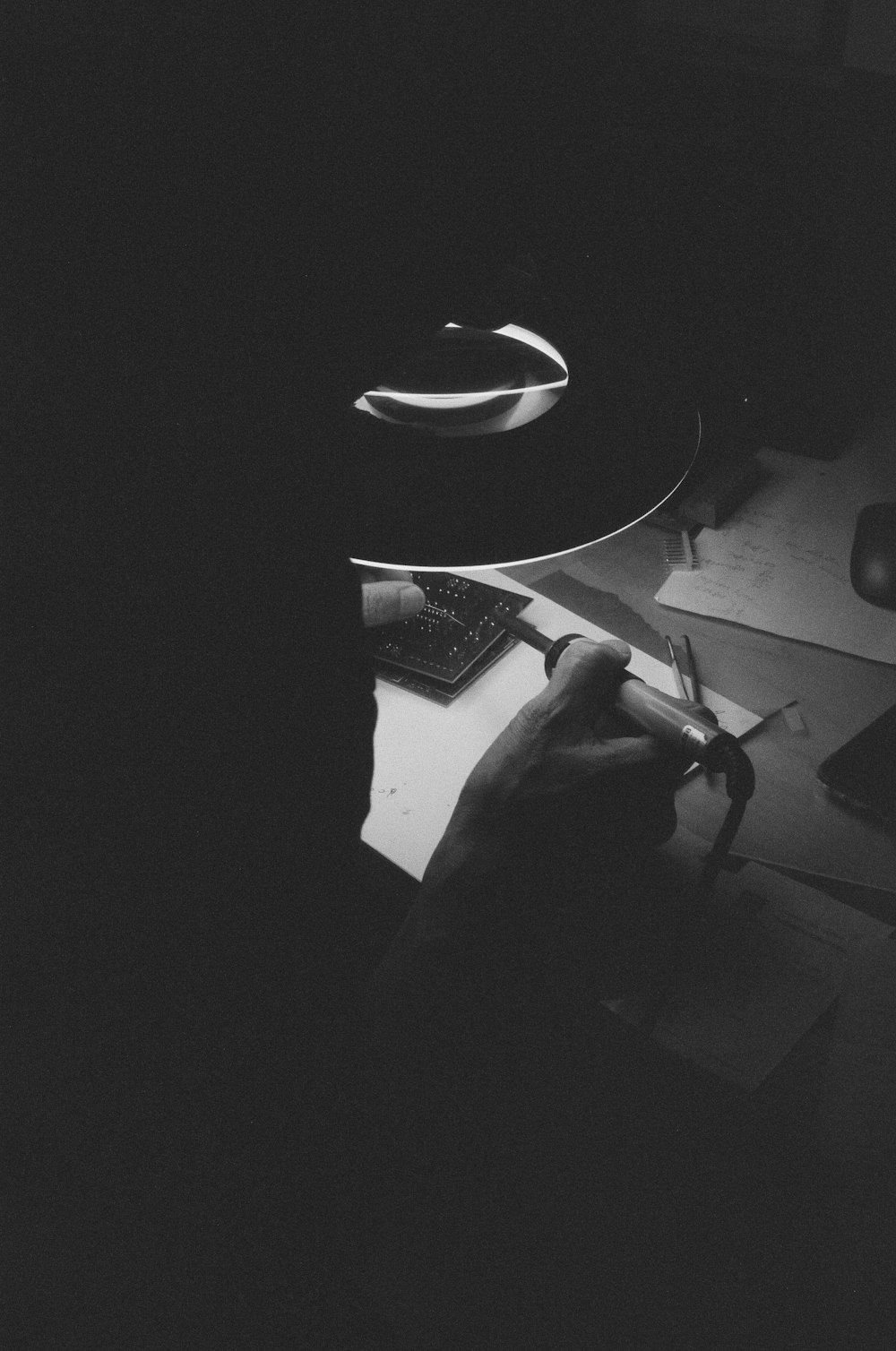 person holding soldering iron