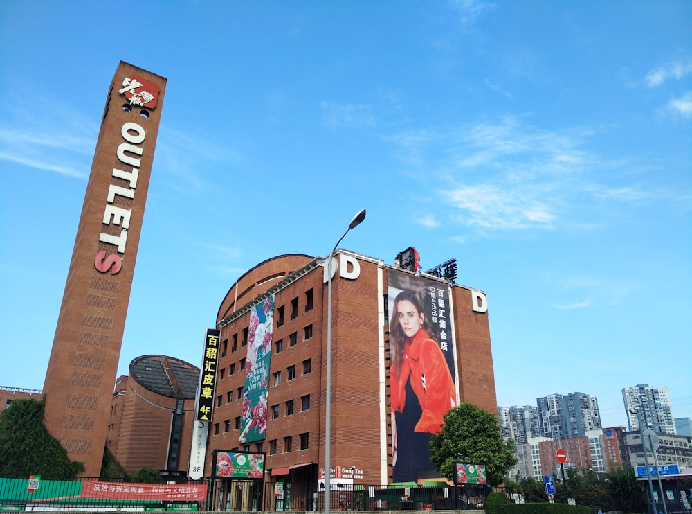 woman wearing red top billboard on brown building