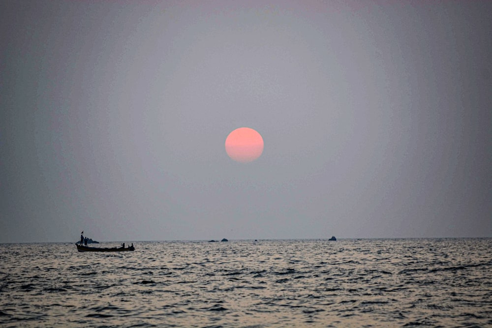 silhouette of boat on ocean