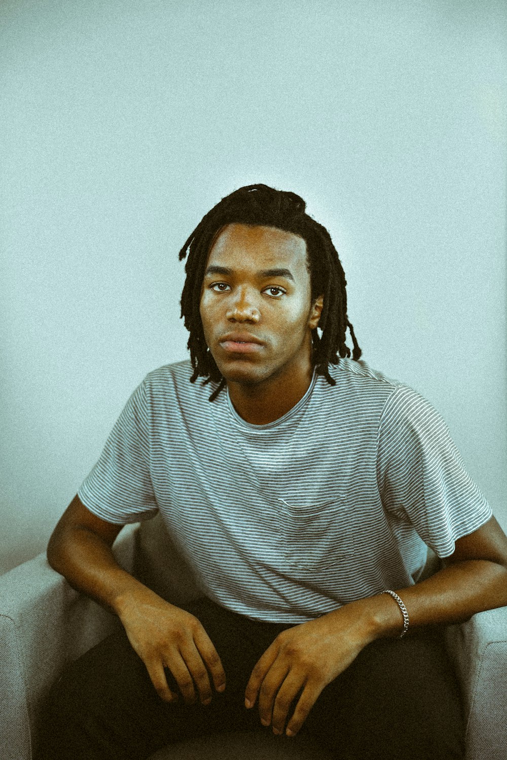 man sitting near wall