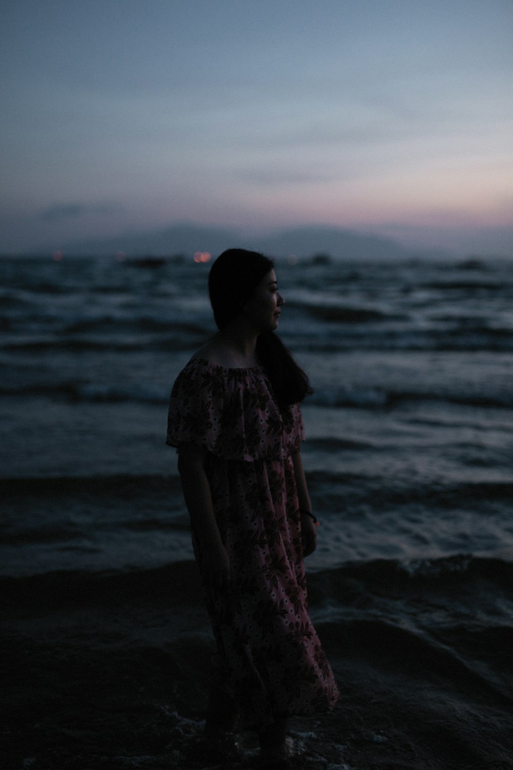 woman standing on body of water at daytime