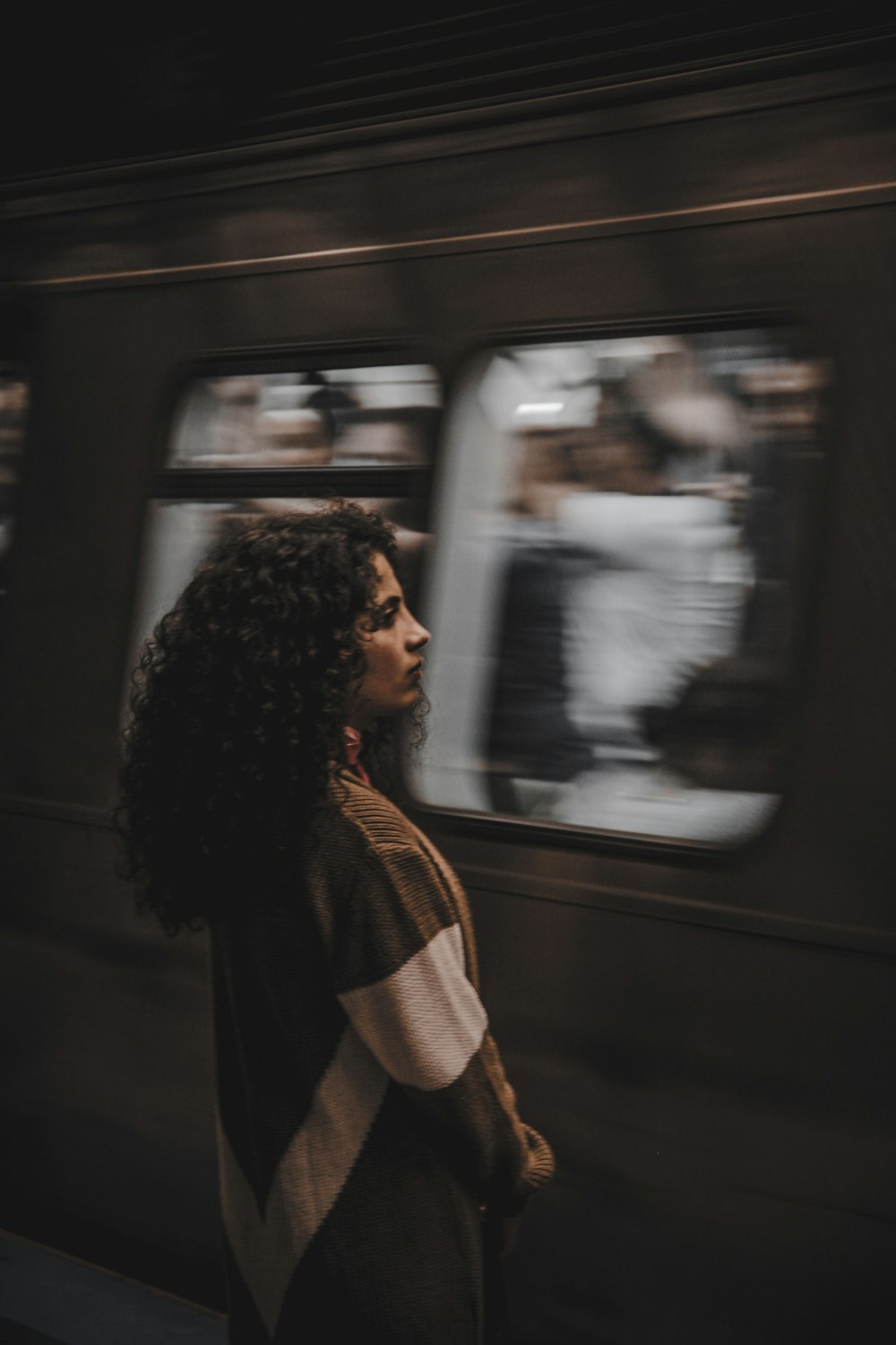 woman standing beside train