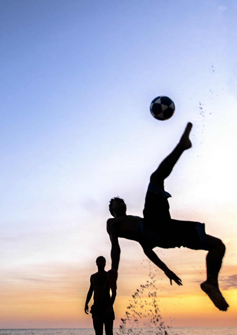 silhouette photography of person playing soccer