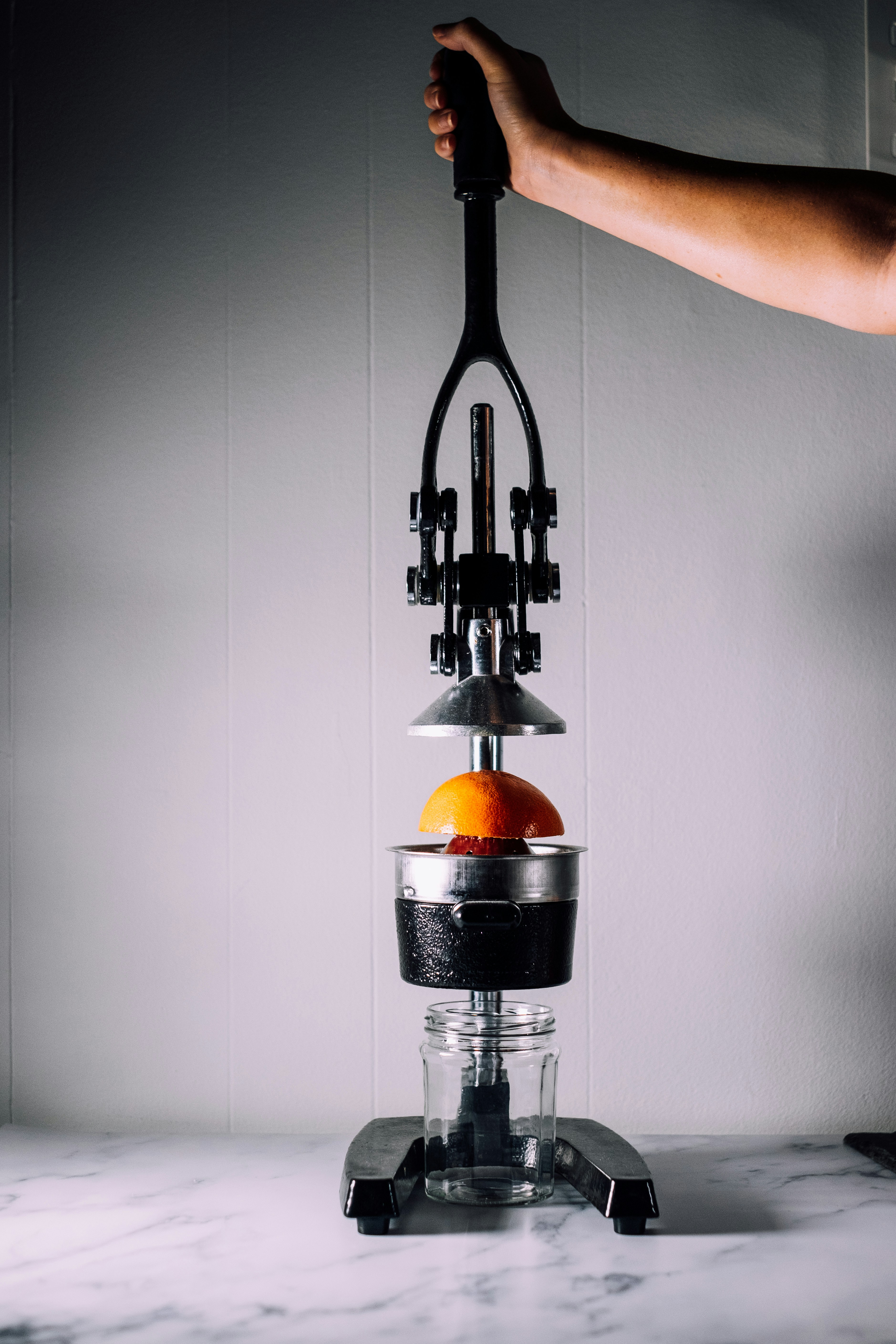 person using citrus juicer