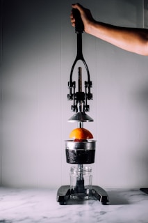 person using citrus juicer