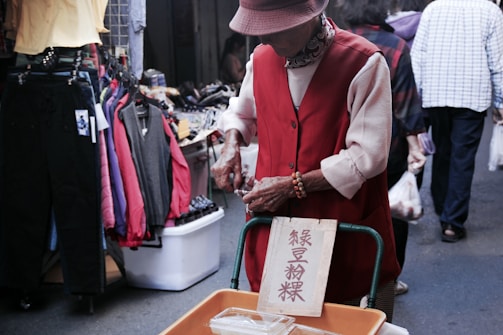 An assistant helping an elderly person with groceries.