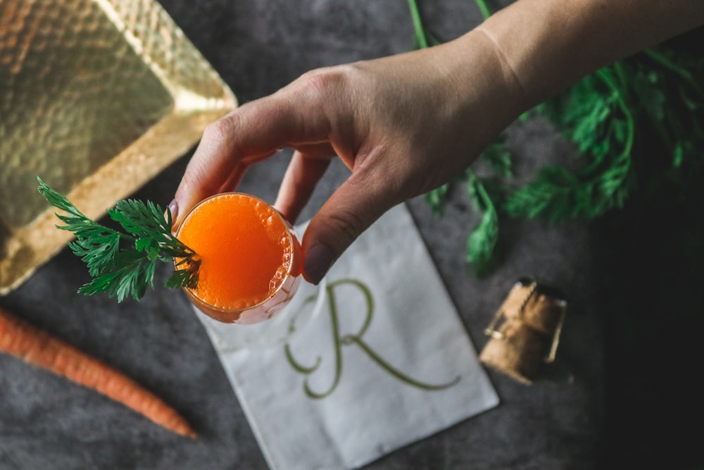 person holding cocktail glass